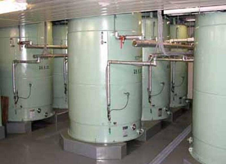 Large industrial tanks with pipes and valves, likely part of a manufacturing or processing facility. 2
