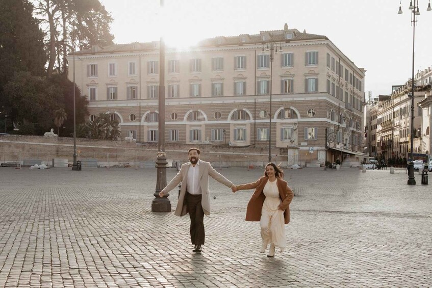 A couple walking on a cobblestone street with a historic building in the background. 4