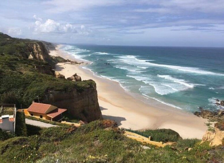 A coastal landscape with cliffs, a sandy beach, and a clear sky. 2