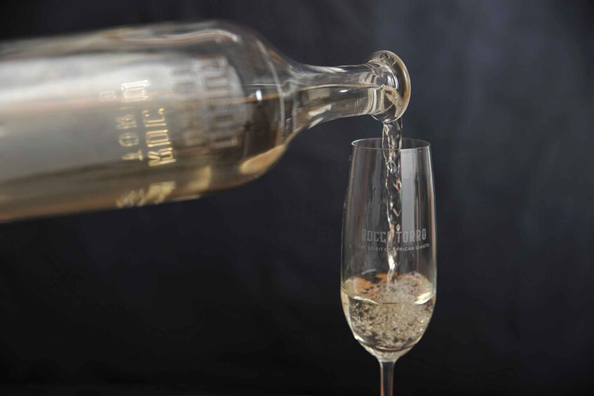 A bottle pouring liquid into a glass. 5