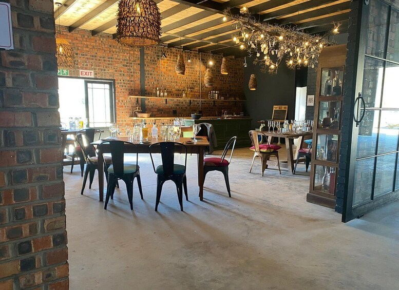 A restaurant interior with brick walls, wooden tables, and hanging light fixtures. 2