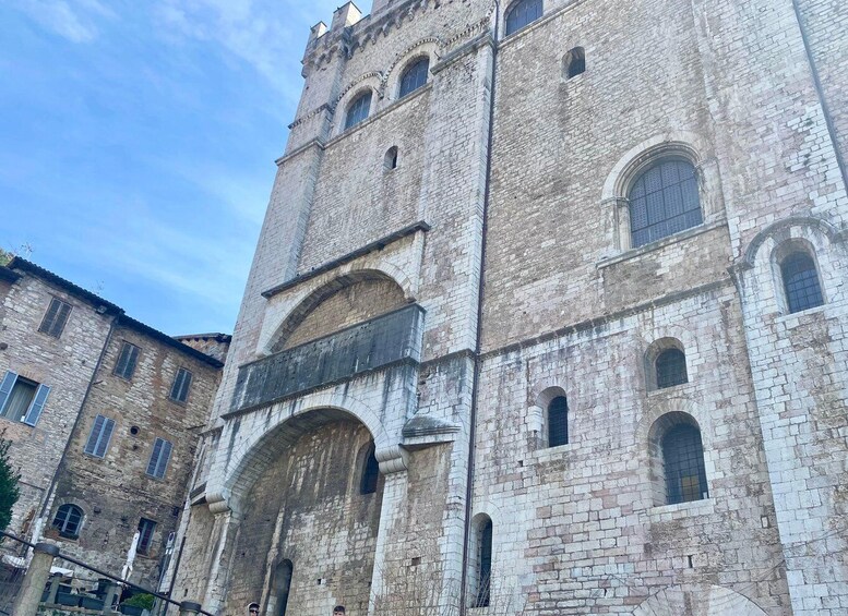 A historic stone building with arched windows and a central entrance. 2