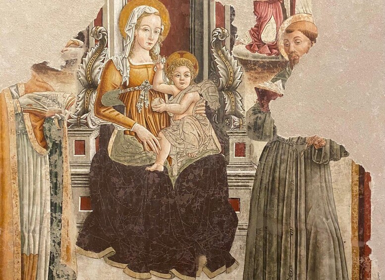 A fresco with a central figure holding a child, surrounded by ornate architectural elements and other figures. 4