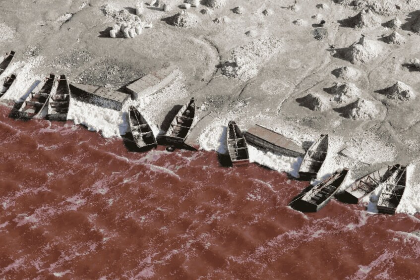 A coastal area with a series of breakwaters extending into the sea, protecting the shoreline. 4