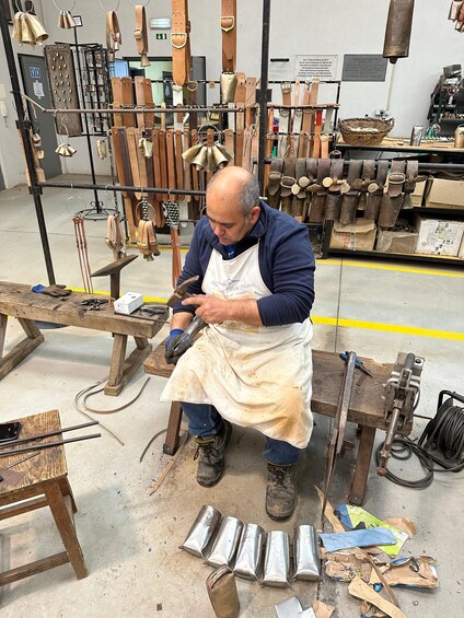 A person working with metal tools in a workshop. 3