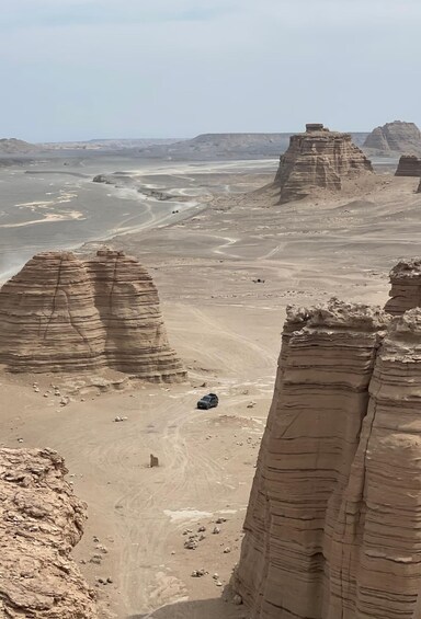 A desert landscape with prominent rock formations and a winding river. 1