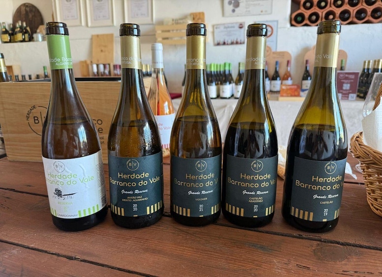 Five bottles of wine with labels indicating they are from the Herdade Barranco do Vale estate. 4