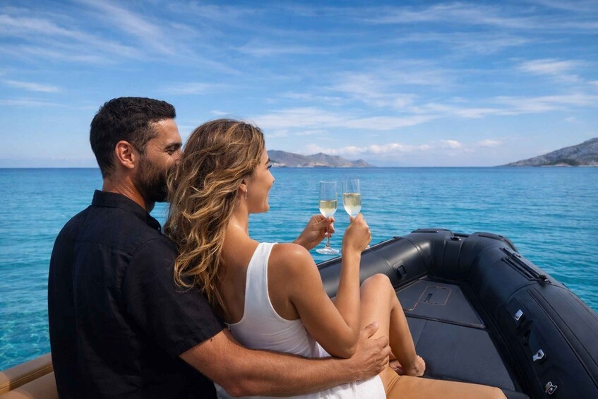 A couple on a boat with a clear view of the sea and distant mountains. 3