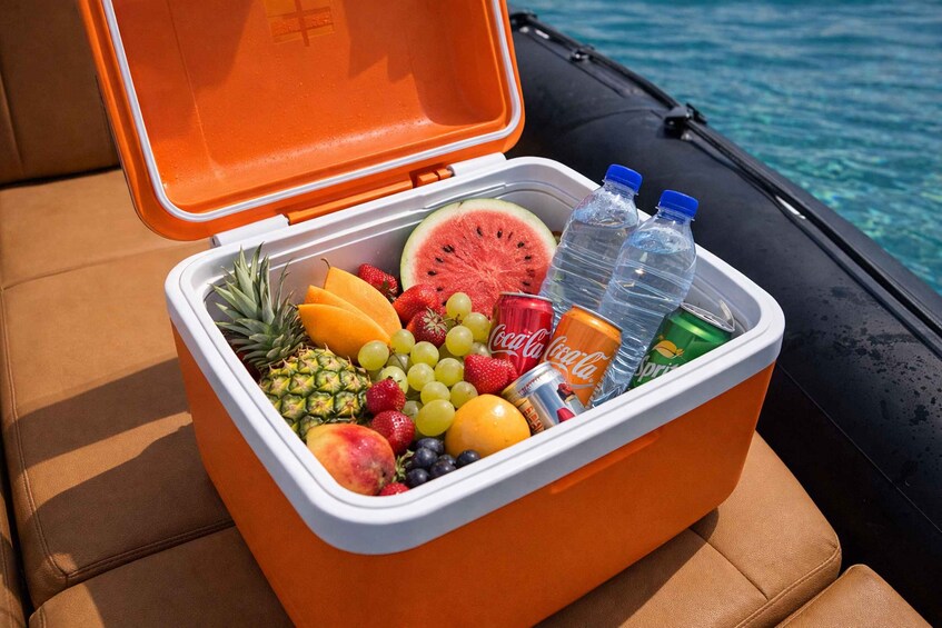 A portable cooler filled with fruits, water bottles, and beverages on a boat. 2