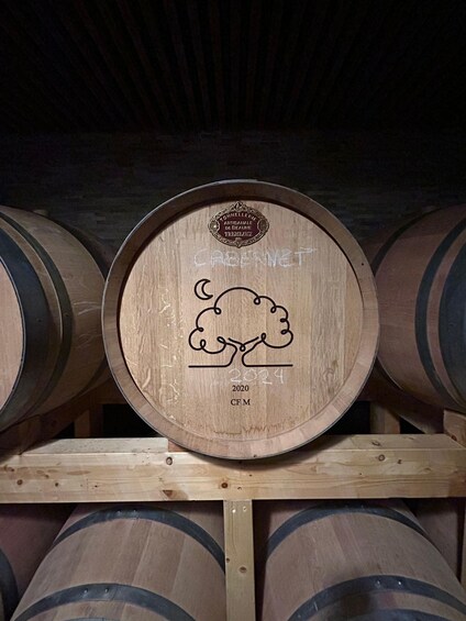 Wooden wine barrels stacked on wooden shelves. 2