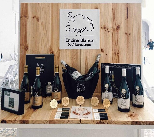 A wine display with bottles and medals. 1
