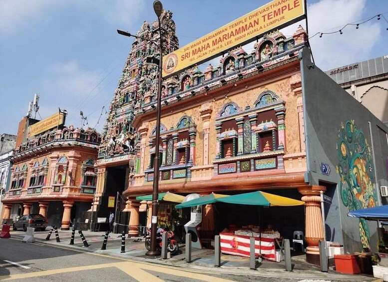 A colorful temple with intricate carvings and a signboard. 3