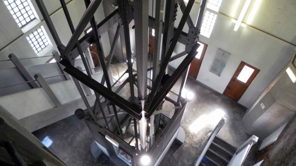 A metal framework structure, possibly a part of a building or machinery, with a staircase leading to an upper level. 2