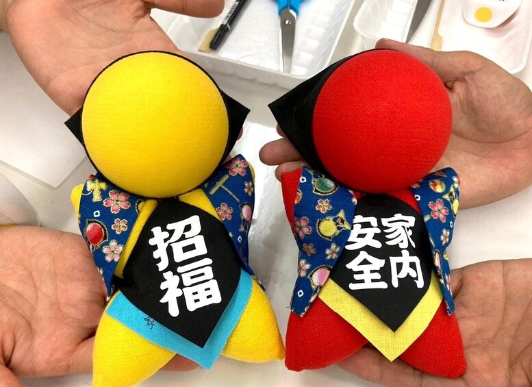 Two plush toys with Japanese text on their chests. 2