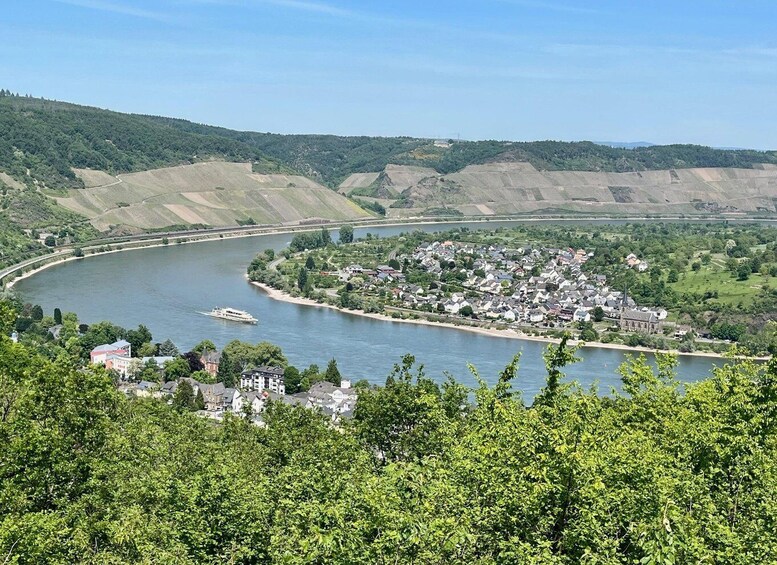 A river curving through a town surrounded by hills. 4