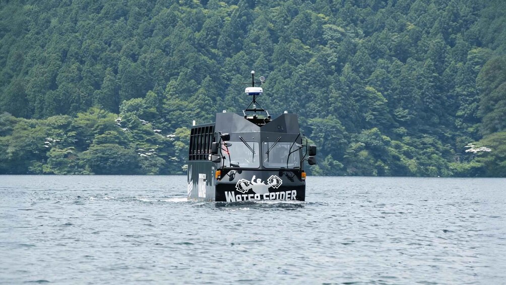 A watercraft named 'Water COTTER' on a lake with a forested shoreline in the background. 5