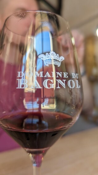 A wine glass with 'Domaine du Bagnol' engraved on it. 5