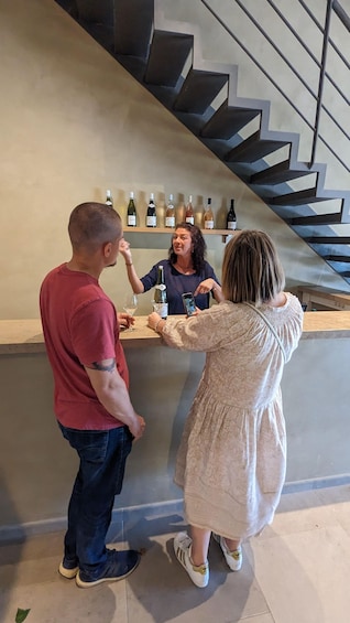 A bar area with a counter and a staircase in the background. 1
