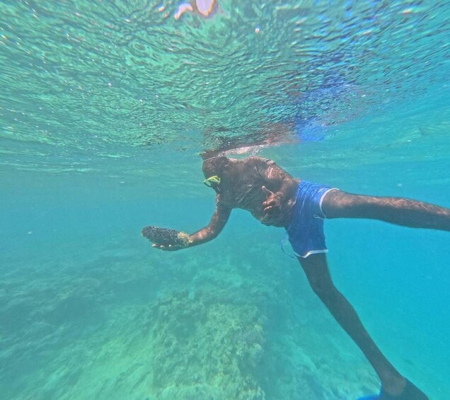 A person swimming underwater with fins. 2