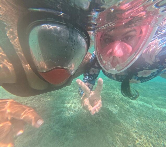 A person underwater with a snorkel and mask, reaching out towards the surface. 4