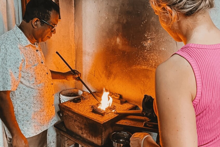 A person cooking with a fire. 1