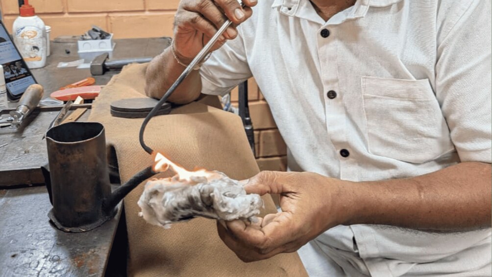 A person working with a tool on a piece of material. 5