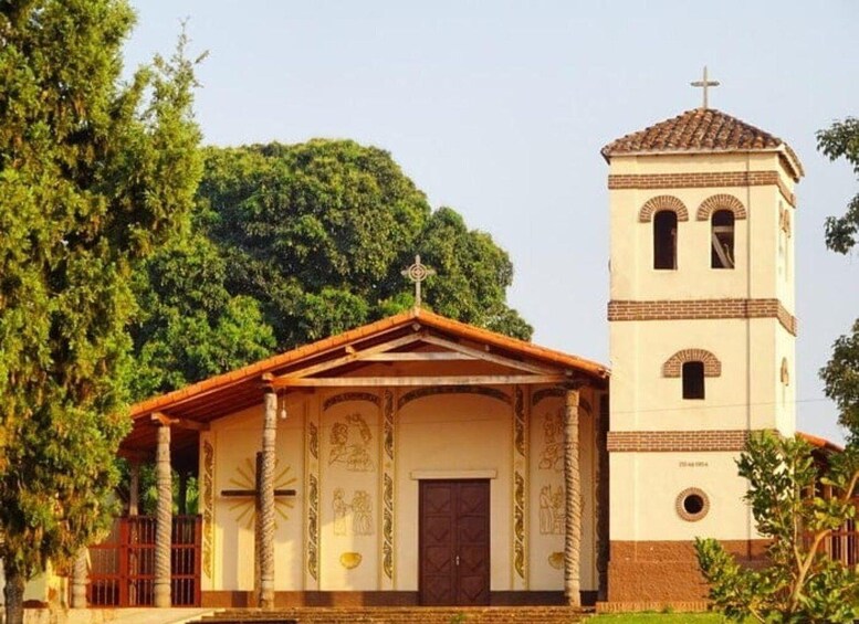 A church with a bell tower and a small chapel. 4