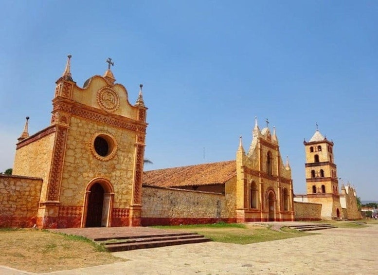 A historic church with a bell tower and a large circular window. 1