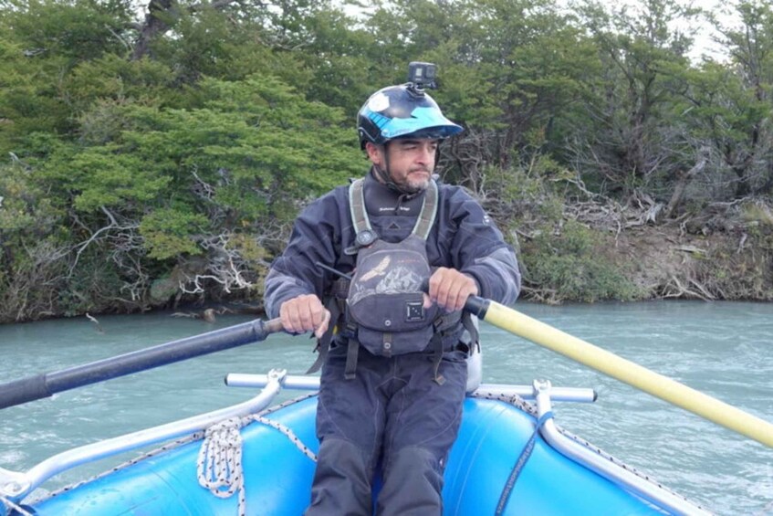 A person in a kayak on a river surrounded by dense greenery. 2