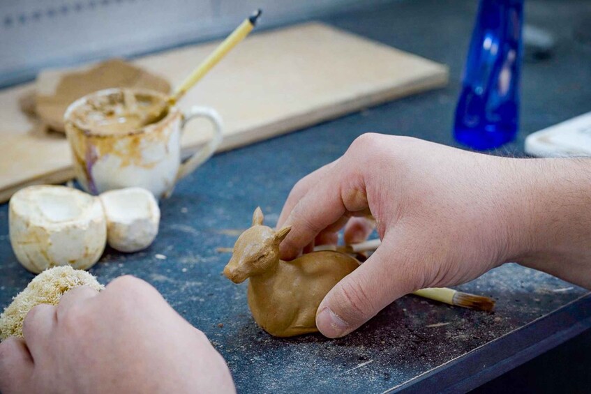 Hands shaping dough on a kitchen counter. 1