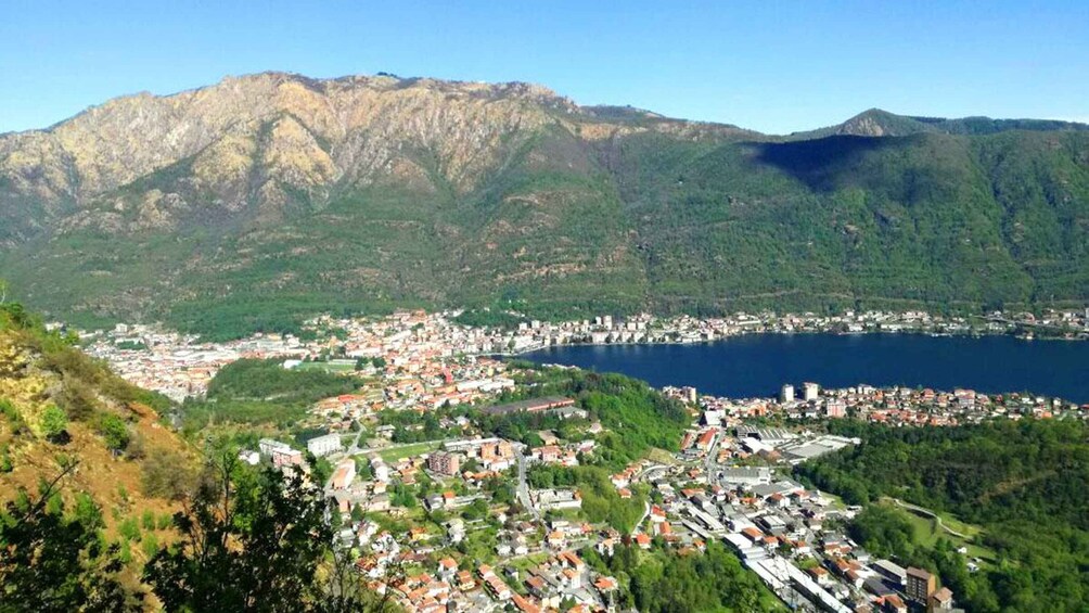 A coastal town with a large body of water, surrounded by mountains. 1