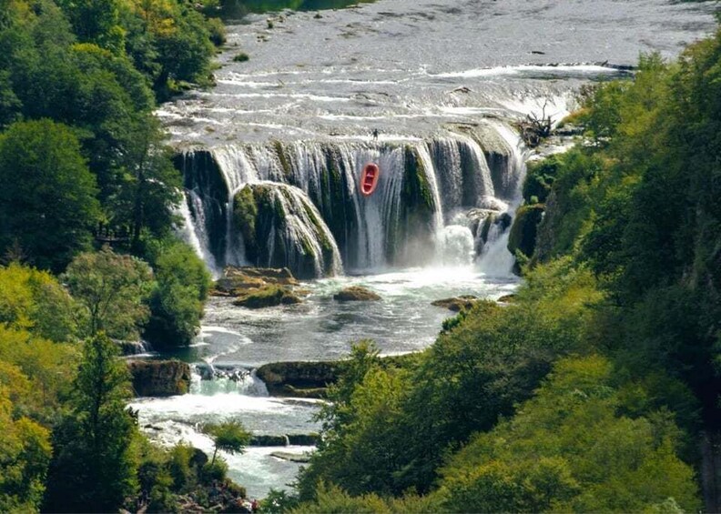 A multi-tiered waterfall surrounded by lush greenery. 2