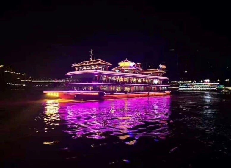 A brightly lit riverboat with a traditional design, reflecting on the water. 4