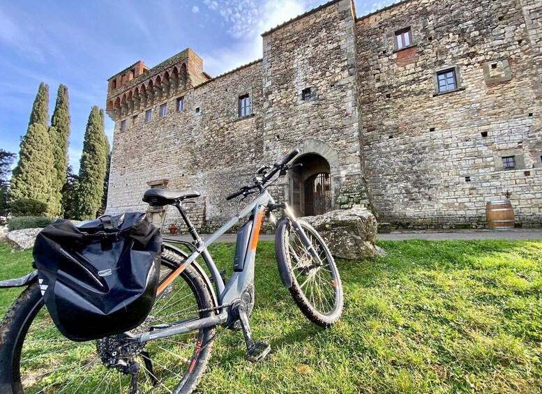 A stone building with a bicycle parked in front. 3
