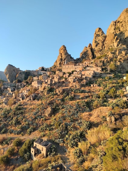 A village nestled in a mountainous region with traditional stone buildings. 1