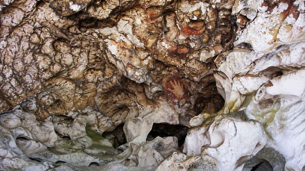 A cave interior with stalactites and stalagmites. 5