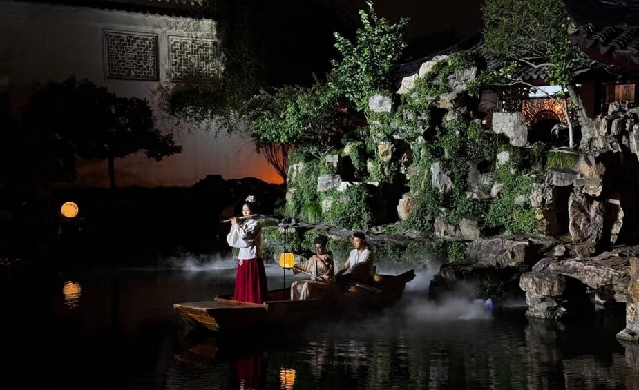 A traditional Chinese water scene with a boat, musicians, and a rocky garden backdrop. 3