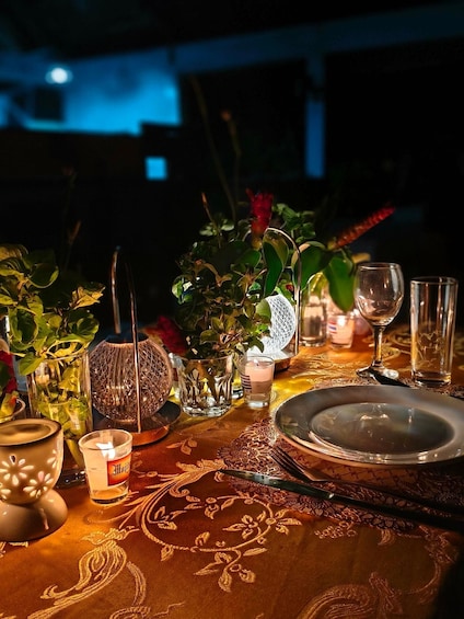 A table set for a meal with various dishes, glasses, and a candle. 3