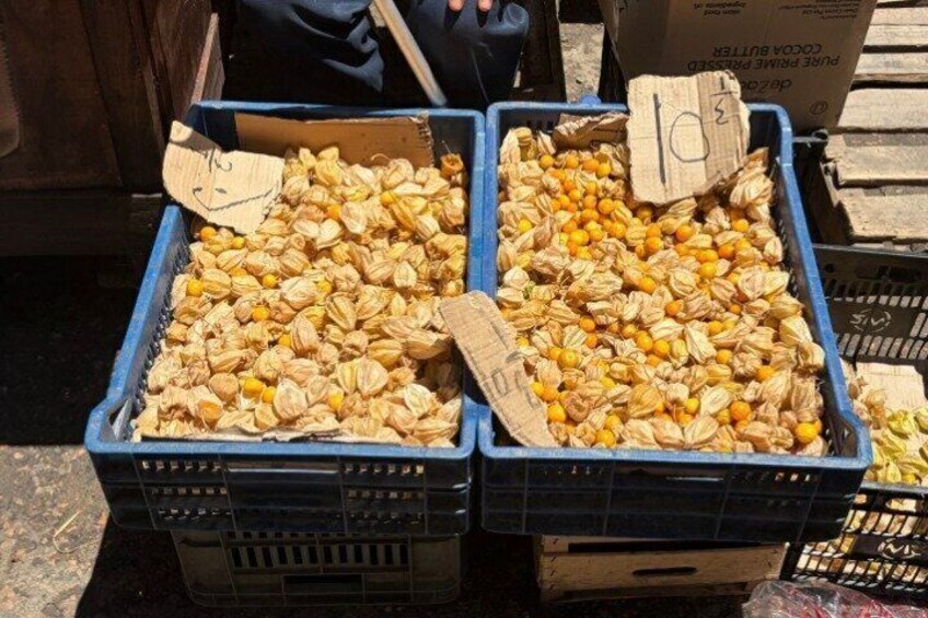 Two blue crates filled with dried fruits, possibly star fruits, with price tags. 5