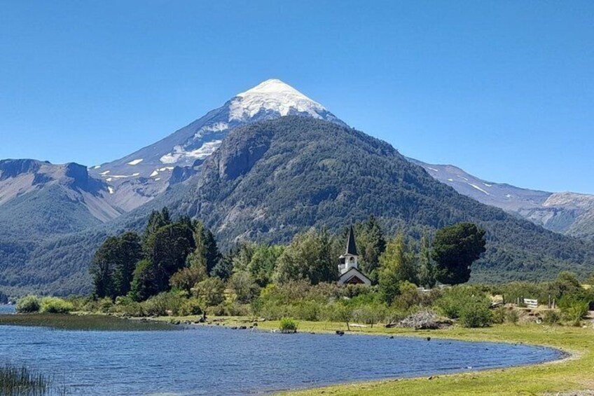 A lake, a church, and a snow-capped mountain. 4