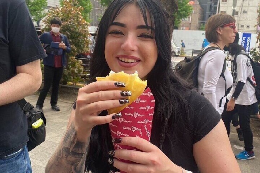 A person holding a sandwich with a red wrapper. 1