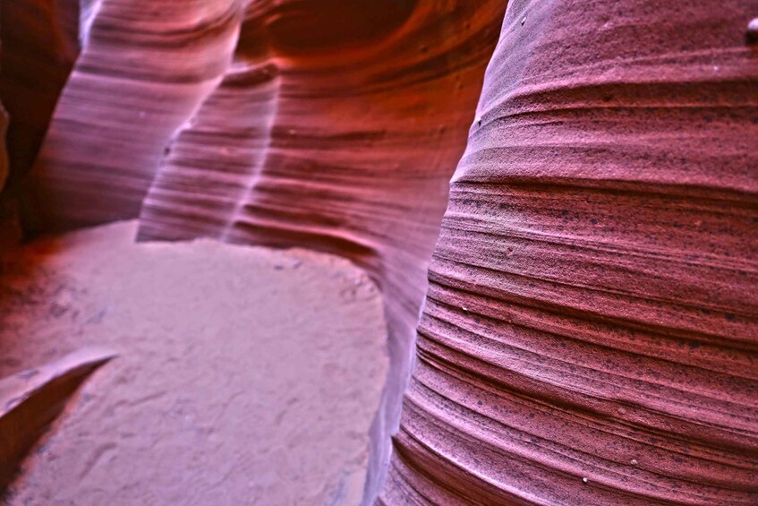 A close-up of layered rock formations with striations. 3