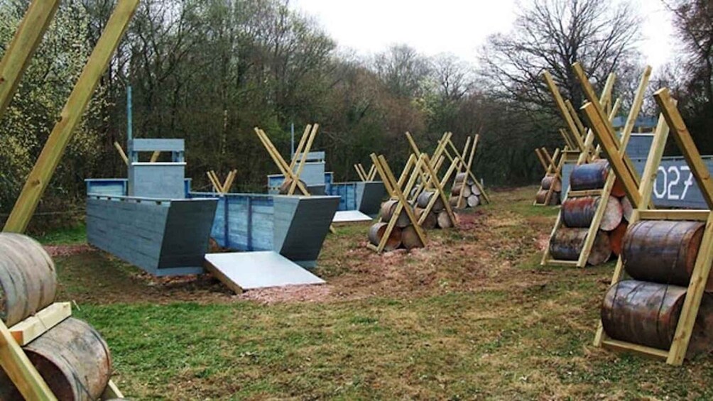 A construction site with wooden structures, metal sheets, and logs. 2