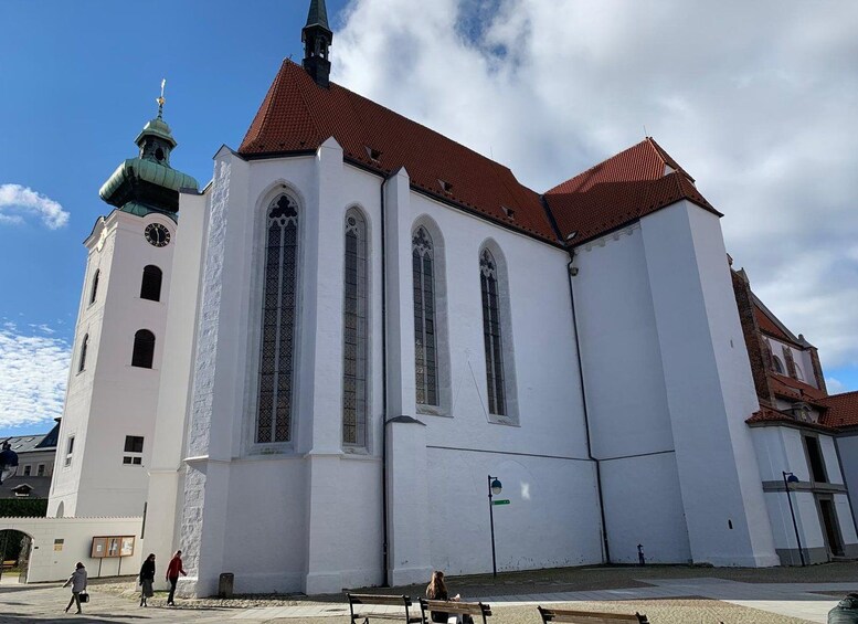 A white church with a red roof and a clock tower. 4