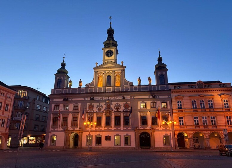 A historic building with a clock tower, ornate decorations, and a clear sky. 3