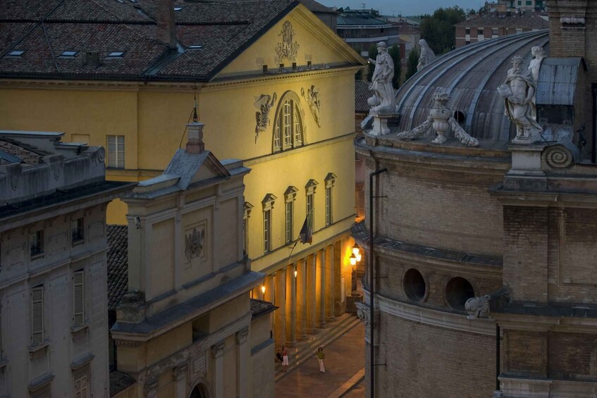 A historic building with classical architecture, including columns and statues. 2