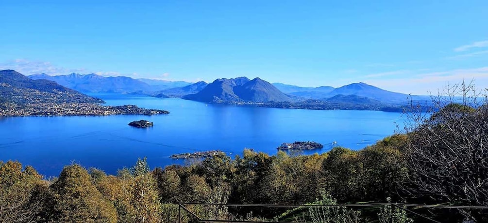 A lake surrounded by mountains and forested areas. 1