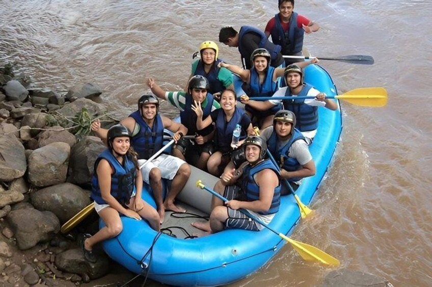 A group of people in a blue inflatable raft on a river. 2