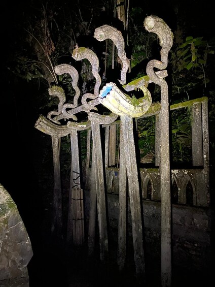 A sculpture of intertwined figures in a forest. 3