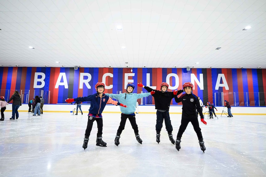 An indoor ice skating rink with a large 'BARCELONA' sign in the background. 1